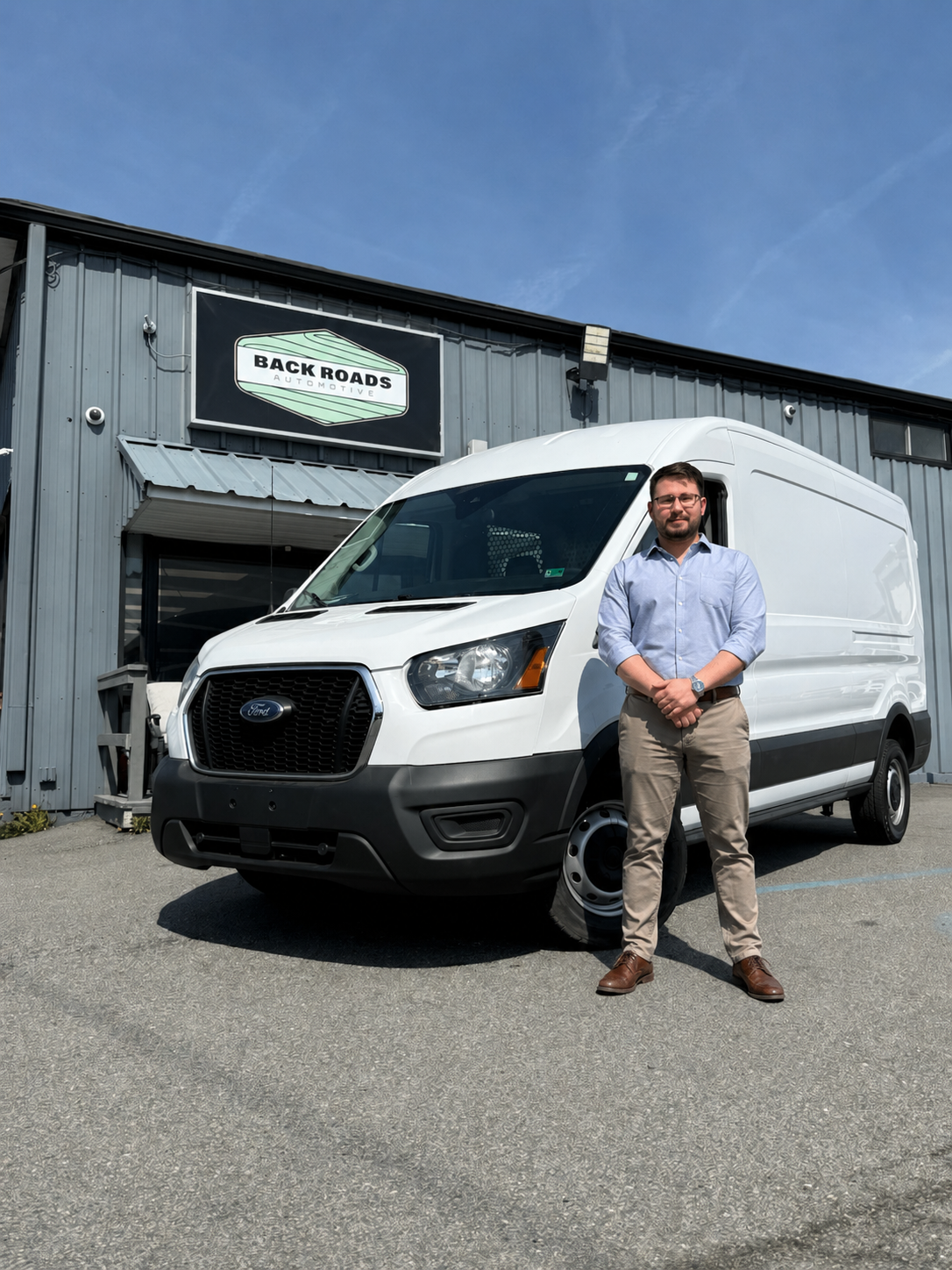 Rivera Colon Supply & Logistics LLC owner standing beside a company delivery van